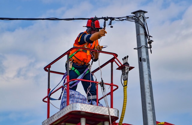 Rigger working at height on a telecommunications mast with safety equipment